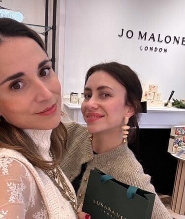 Maria Jose Dorman shares a moment with designer Susana Vega at the Jo Malone Boutique in Market Street in The Woodlands.  Vega is wearing earrings of her own design. (Photo courtesy of Nadia Gill)