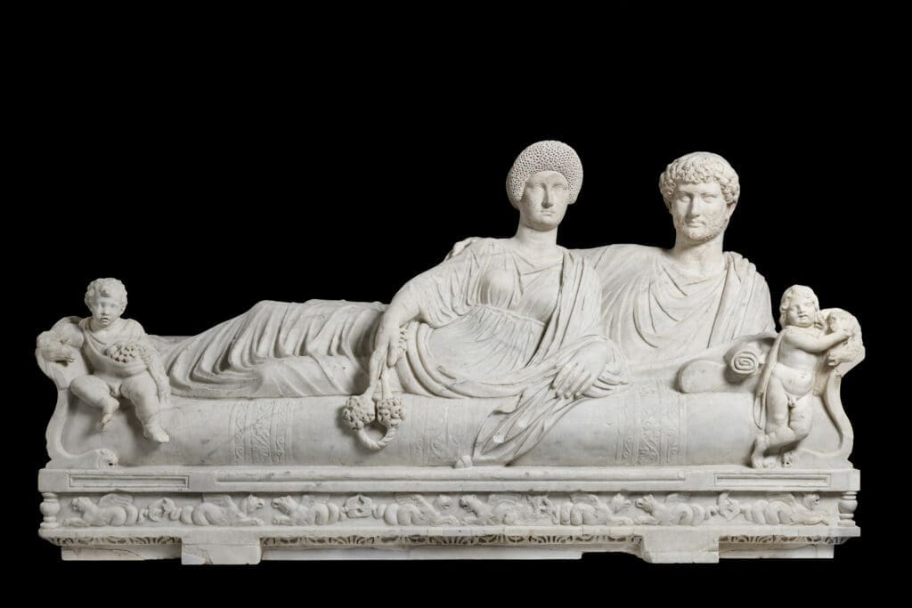 "Lid with Reclining Couple" is a poignant representation of eternal companionship in Roman funerary art. (Courtesy of Torlonia Foundation)