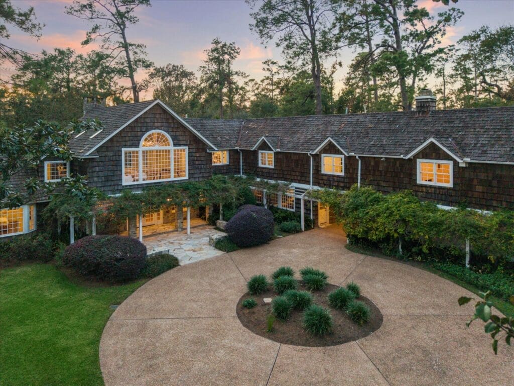 Entry to the residence is via shaded driveway that leads to a circular motor court (Photo by TK Images/Compass)