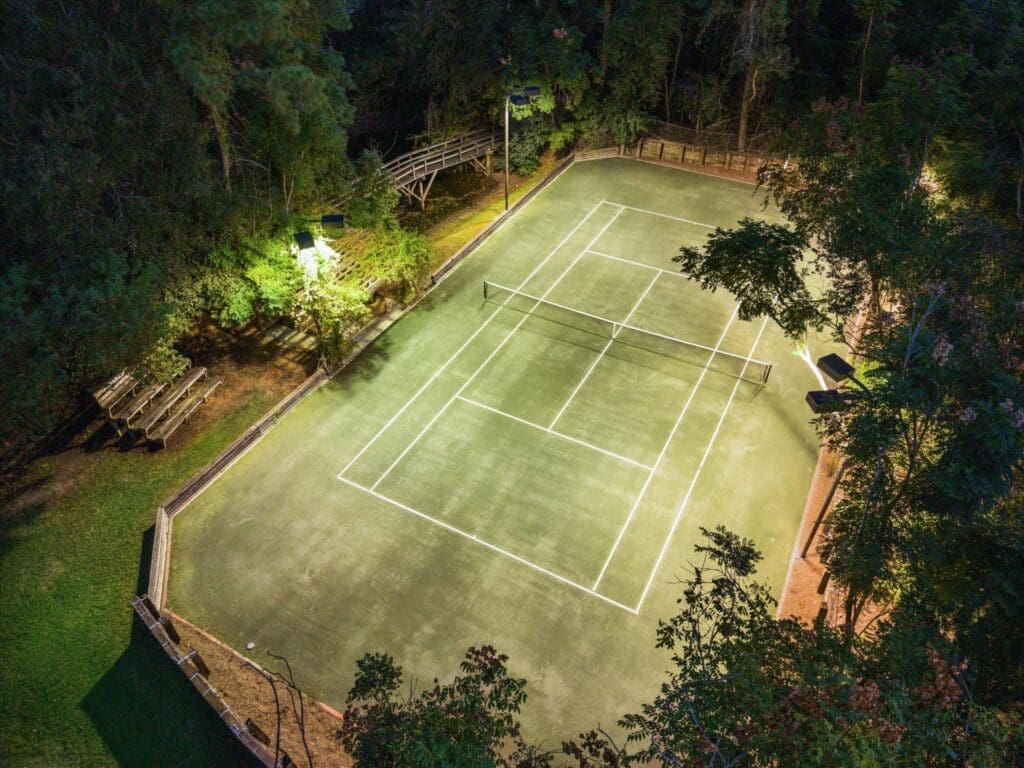The lighted, full-sized clay tennis court at 8899 Sandringham (Photo by TK Images/Compass)