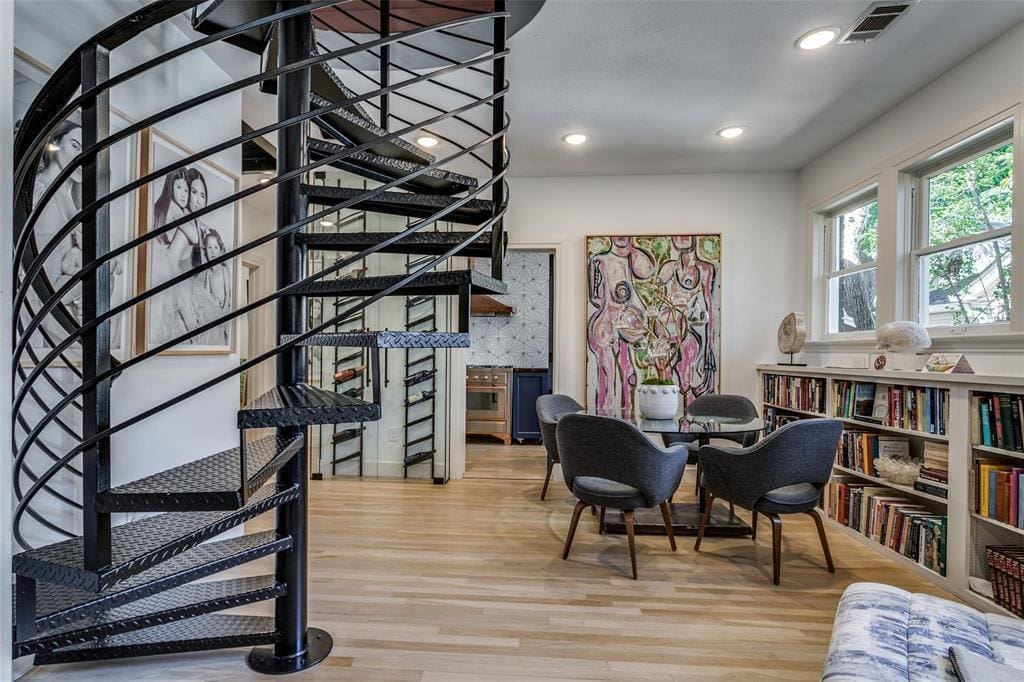 A spiral steel staircase leads to the converted attic loft space at 1023 North Edgefield Avenue.
