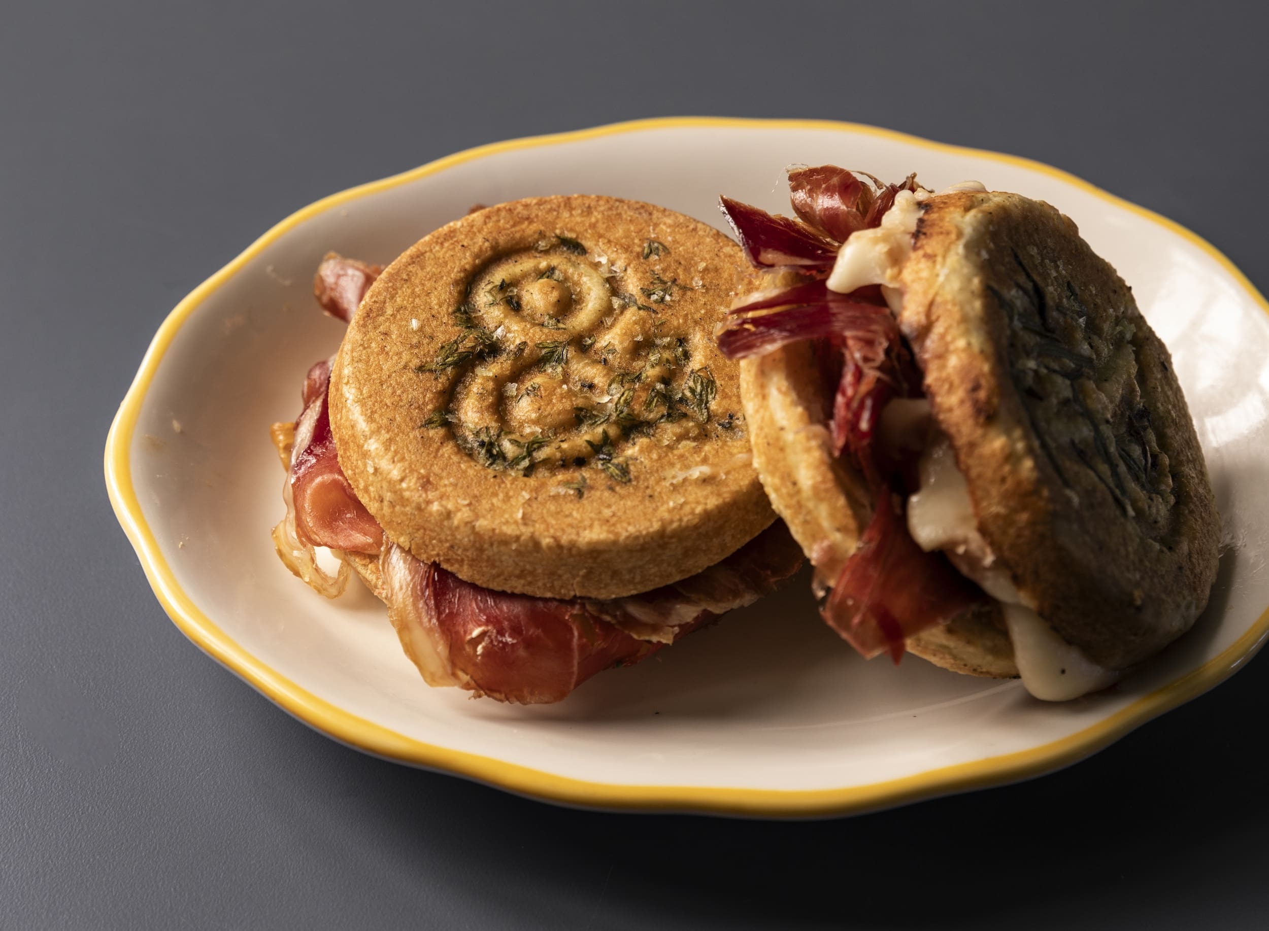 Lee's tigelle pressed sandwich, a housemade flatbread similar to an English muffin layered with ham, sliced apples, honey, and taleggio cheese ($11). (Photo by Julie Soefer)