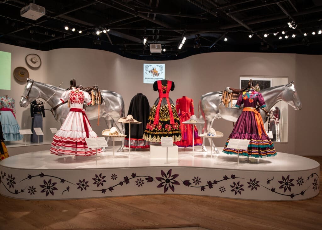 The National Cowgirl Museum exhibit showcases the vibrant dresses and rich traditions of escaramuza charra, celebrating the artistry, heritage, and cultural significance of Mexico's equestrian women. (Rachel DeLira)
