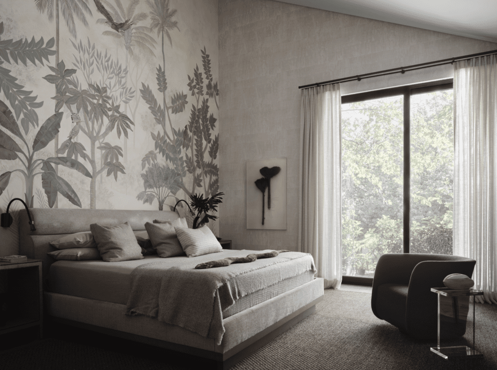 A mural in the main bedroom is by Priscila Gonzalez Urrea. Baker Furniture bed, Peacock Alley bed linens. Framed antique brooms from Karakanagues New York Antiques and Collectibles. Chair by Bright Chair, Allan Knight table.
(Photo by Douglas Friedman)