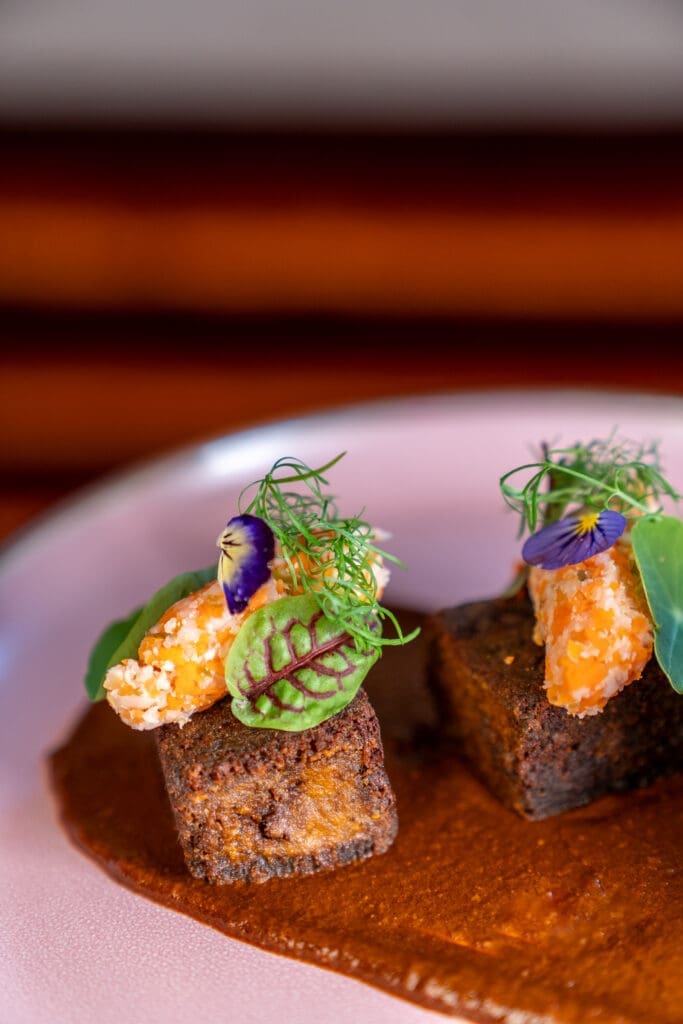 Maximo braised short rib comes mole negro, wild herbs and minced escabeche ($24). (Photo by Carla Gomez)