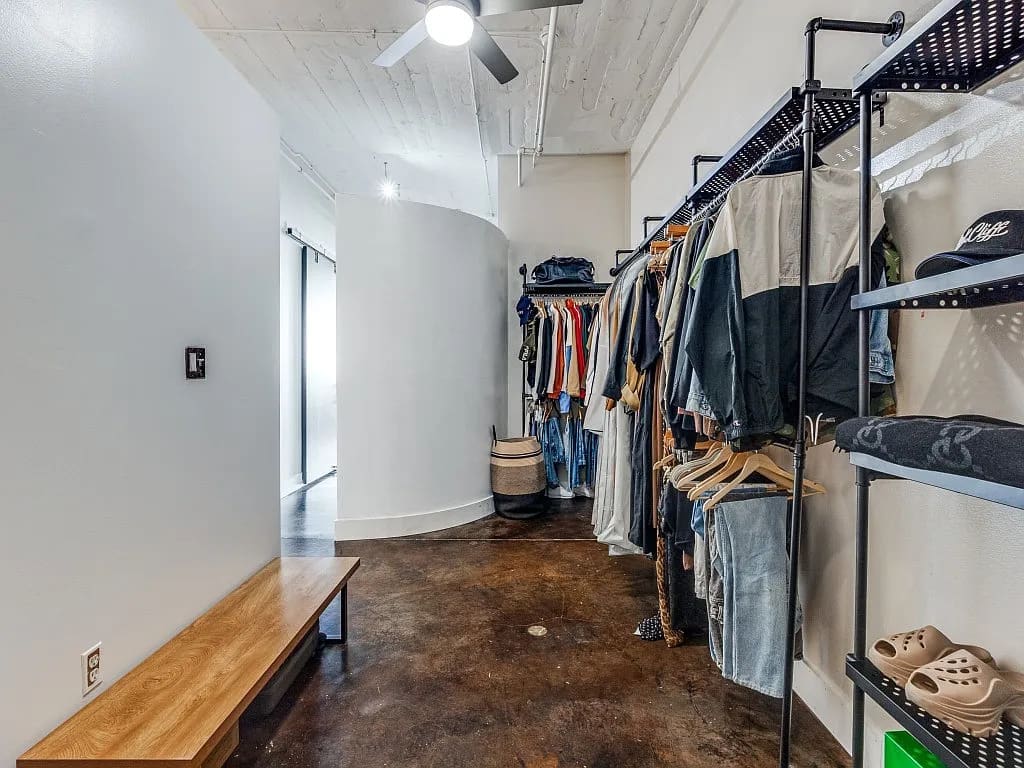 Both the pantry area and the bedroom's closet are large walk-in spaces that cohesively align with the hip, urban aesthetic.