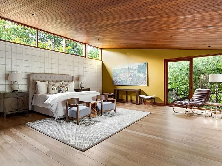 The first floor primary suite offers magnificent views of the landscape. (Photo courtesy of Allie Beth Allman & Associates)