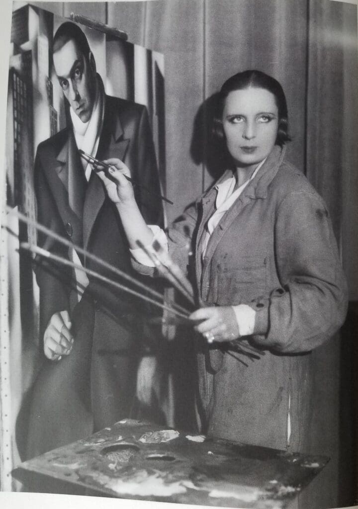 Tamara de Lempicka working on "Portrait of a Man (Tadeusz Lempicki)," circa 1929. (From the book Tamara de Lempicka by Gioia Mori and Furio Rinaldi, Yale University Press © 2024. Bibliothèque historique de la Ville de Paris. Photo by Thérèse Bonney.) 