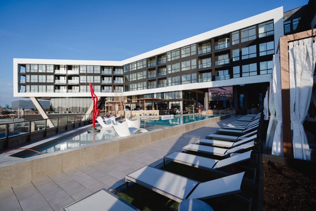 The resort-style pool at One Rangers Way features a swim-up bar, lounge seating, and stunning views of AT&T Stadium. (Courtesy)