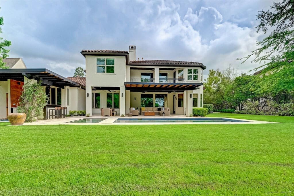 The jaw-dropping backyard of 14 N Player Manor Cir borders on the beautiful golf course. 