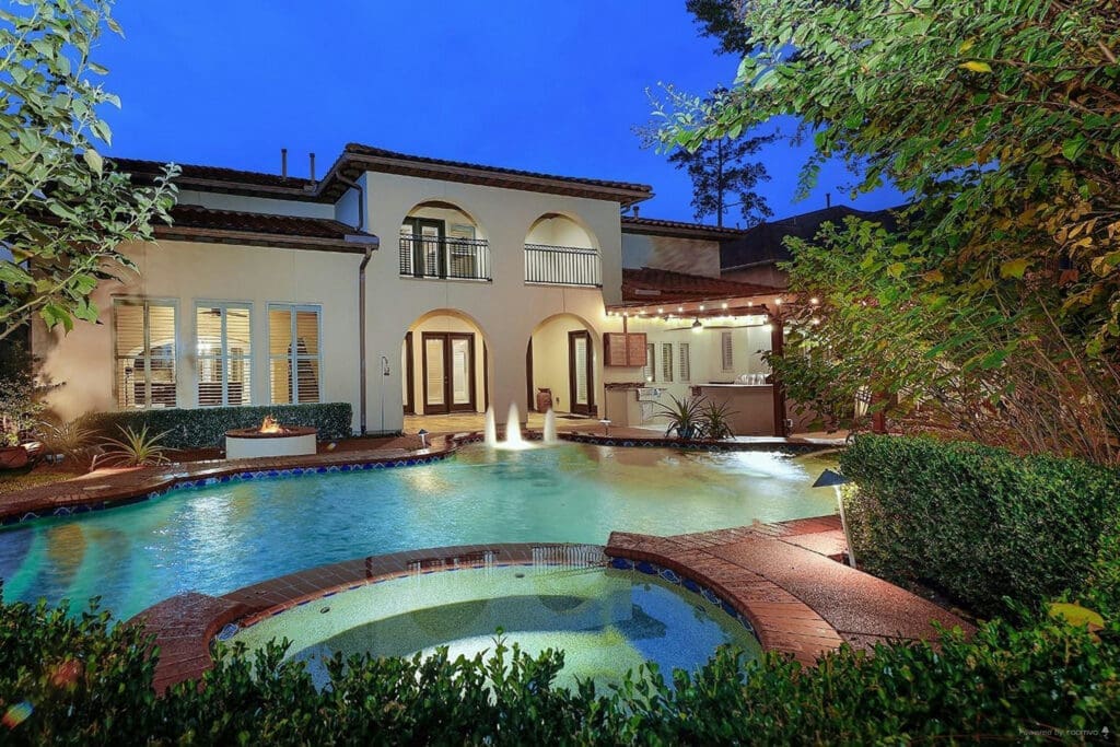 The backyard oasis at 26 N Player Manor Circle has everything you need.
