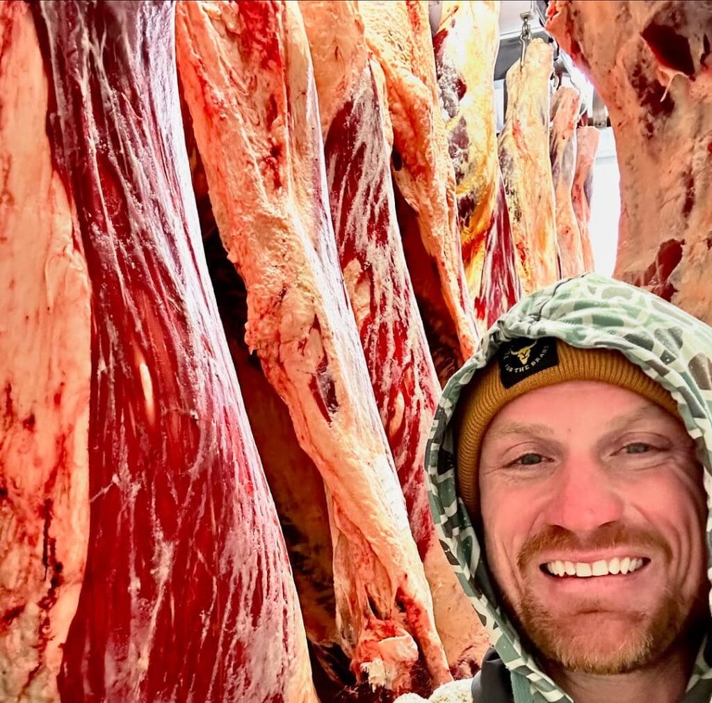 Chef Austin Simmons checks on Wagyu carcasses on the rail as part of his newest venture, Chef and Rancher. (Photo courtesy of Chef and Rancher)