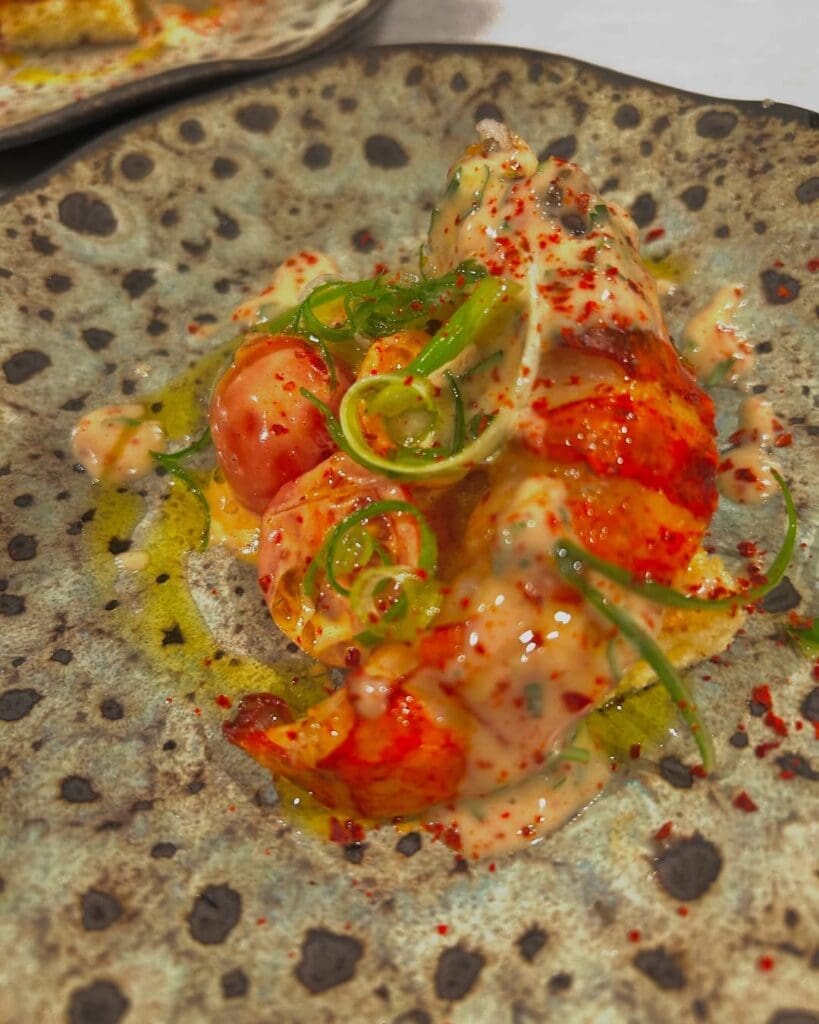 A lobster, brioche, tomato and citrus brown butter emulsion from Chef and Rancher's Austin Simmons shows his skill.