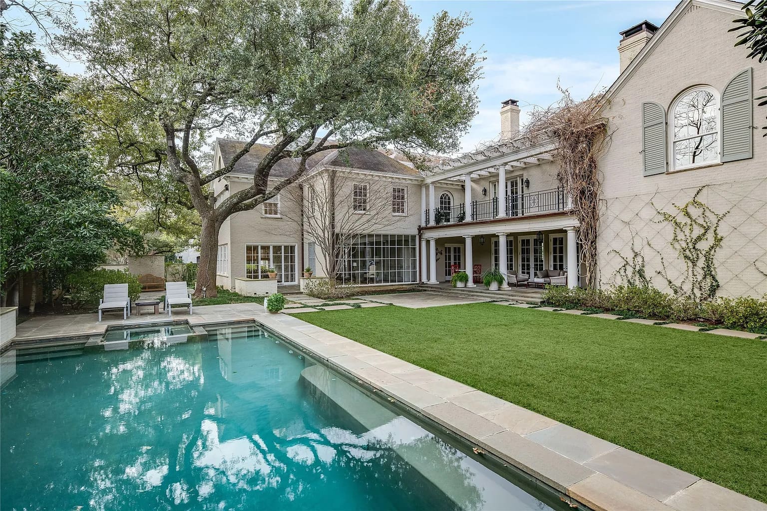 The backyard oasis includes a glimmering pool. (Photo by Allie Beth Allman & Associates)