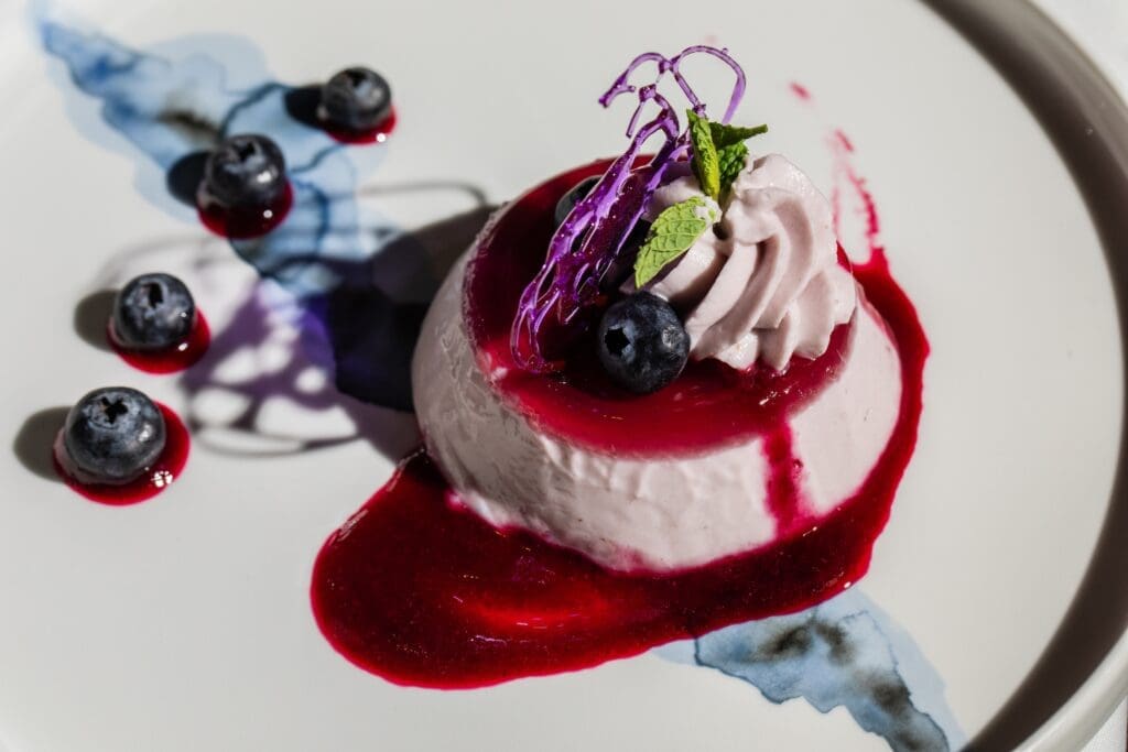 The blueberry panna cotta ($15) at Georgia James is adorned with blueberry gelee and coulis. (Photo by Becca Wright)