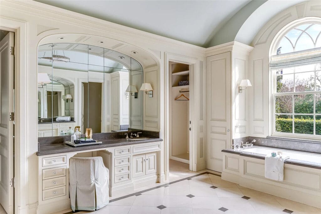 The light-flooded primary bath includes dual vanities and ample space. (Photo by Allie Beth Allman & Associates)