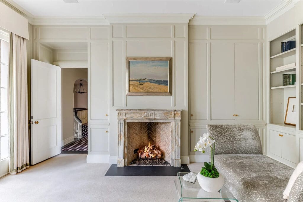 The primary bedroom's sitting area includes a fireplace. (Photo by Allie Beth Allman & Associates)