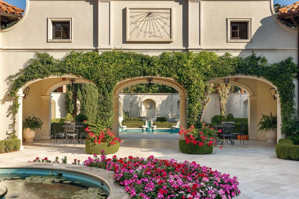 More than an acre of landscaped grounds, filled with azaleas and towering live oaks, transport guests outside of Dallas to the European destinations that inspired much of the design. (Photo by Briggs Freeman Sotheby's International Realty)