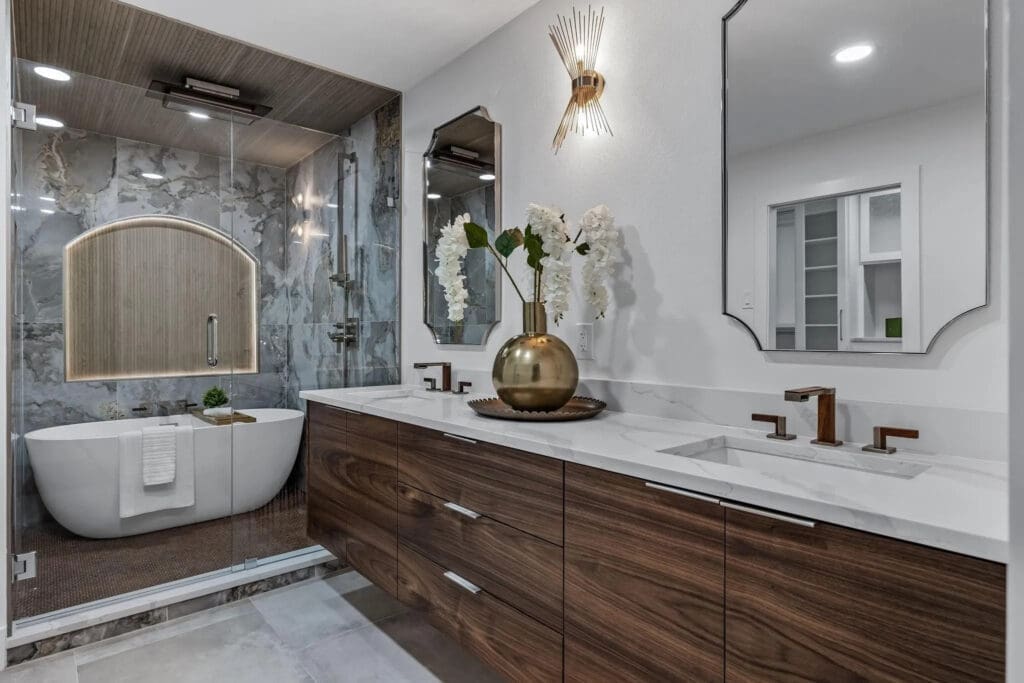 The redesigned bathrooms "exude sophistication," according to the listing, and include quartz, Frank Lloyd Wright collection fixtures, smart toilets, and freestanding bath tubs. (Photo by Compass RE Texas)