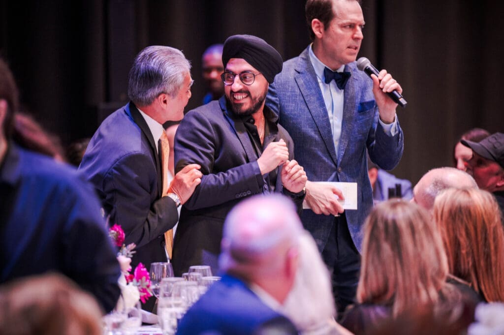 Dr. Hilton Yee, Chef Jassi Bindra and auctioneer Pat Tully during the live auction at the 2025 Pavilion Partners Wine Dinner. (Photo by The Cynthia Woods Mitchell Pavilion)