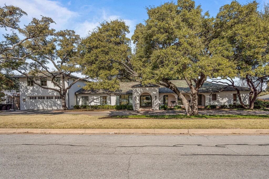 Mature oak trees and a stately façade define this Westover Hills estate’s commanding presence. (Courtesy)