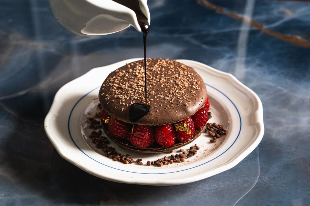 End your meal at Chardon with the decadent "le grande macaron au chocolate" with fresh raspberries and hazelnut gianduja mousse. (Photo by Michael Anthony)


