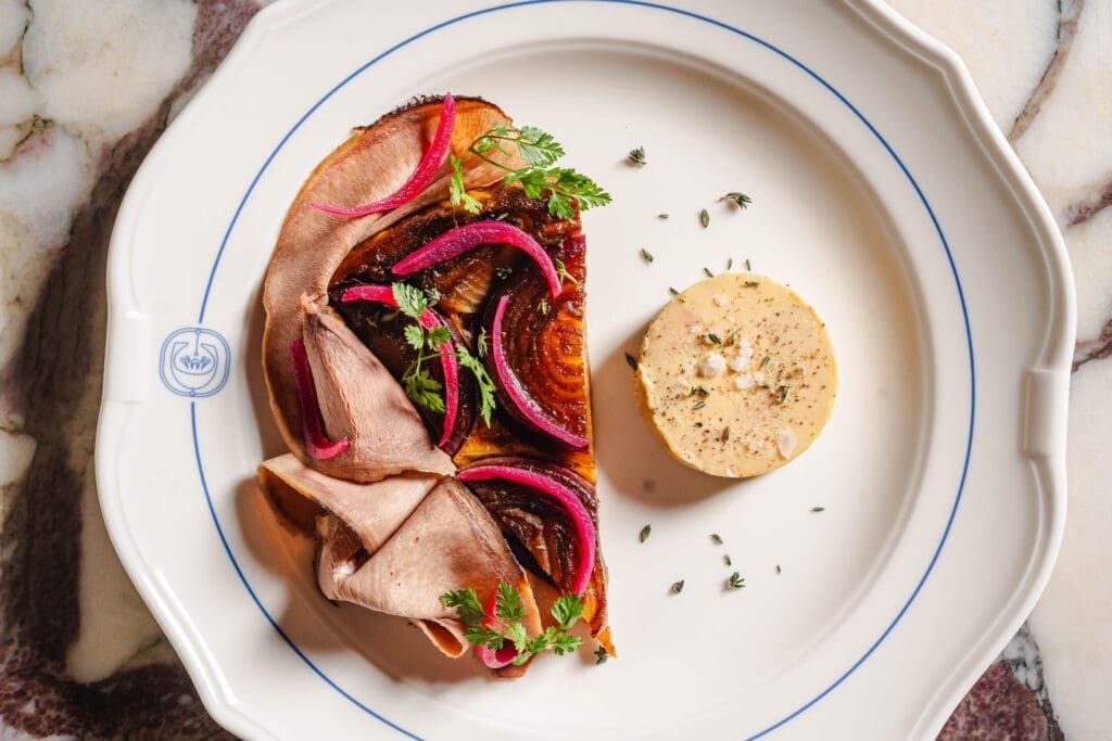 On the other side of the dining room, glass pane doors lead to the Chardon kitchen where executive chef EJ Miller has curated a menu filled with classic French dishes that tip a toque to Texas and the local ingredients he procures here. (Photo by Michael Anthony)