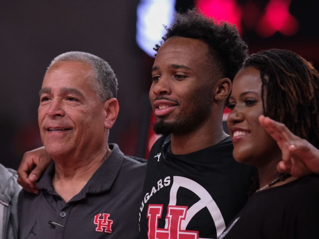 Kelvin Sampson, Big 12 ring master LJ Cryer and Cryer's mom Tamica share a moment on UH's Senior Night. (Photo by F. Carter Smith)