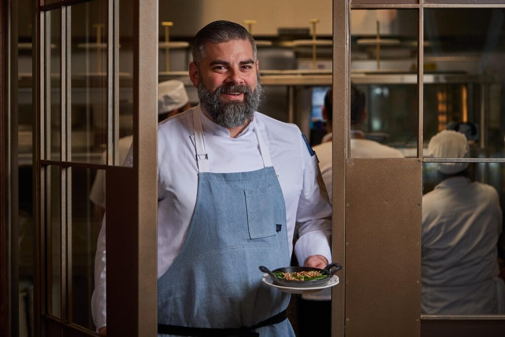 On the other side of the dining room, glass pane doors lead to the kitchen where executive chef EJ Miller has curated a menu filled with classic French dishes that tip a toque to Texas and the local ingredients he procures here. (Photo by David Varley)