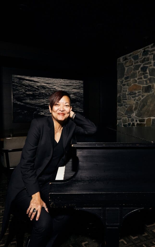 Linda Milagros Violago, the director of the wine program at Canlis, sit at the piano n the famed restaurant. (Photo by Amber Fouts)
