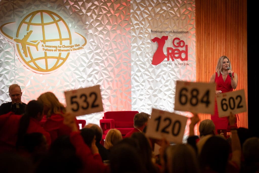 Mission supporters donating at the Go Red for Women luncheon (Photo by See Pink, Inc)
