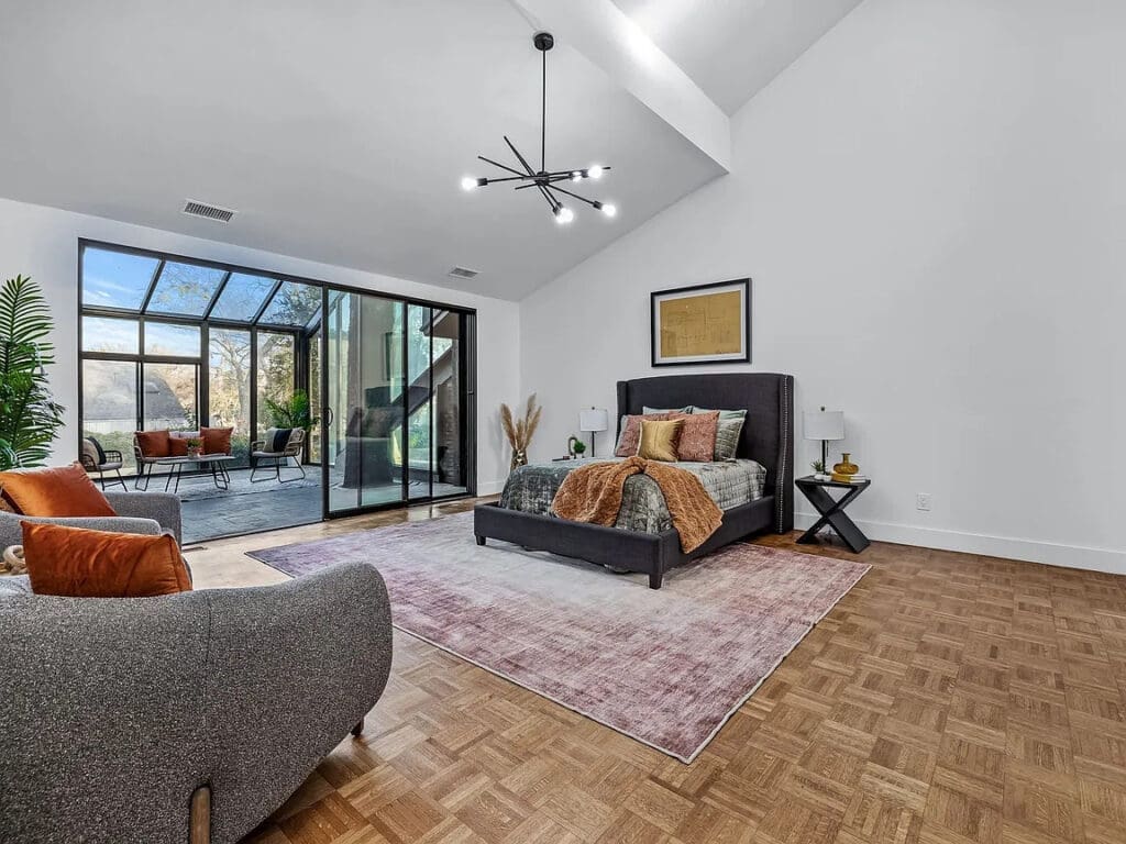 The primary bedroom features an attached light-flooded solarium. (Photo by Compass RE Texas)