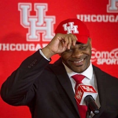 Jettisoned University of Houston women's basketball coach Ronald Hughey calls the day he was hired his best day at UH and he uses that image on his Twitter and Instagram bios. (@CoachHughey1)