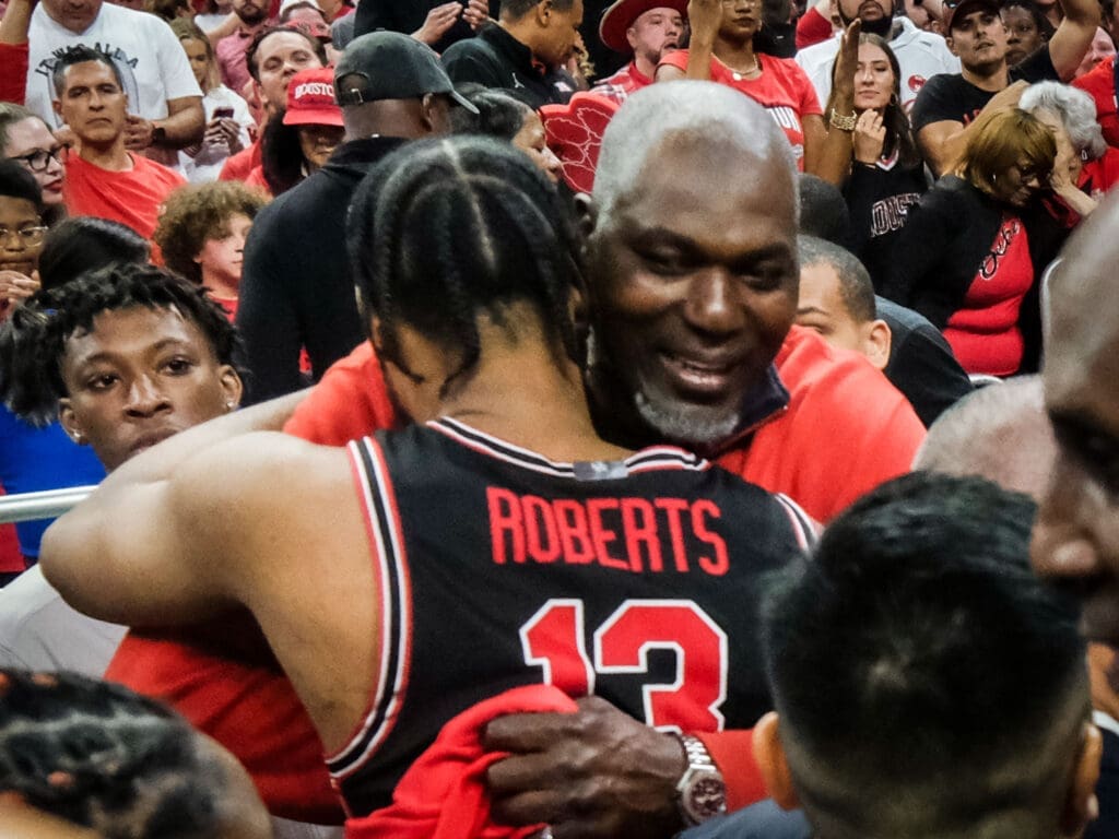Hakeem Olajuwon wrapped J'Wan Roberts up in a hug after University of Houston's comeback for the ages against Duke in the Final Four. (Photo by F. Carter Smith)