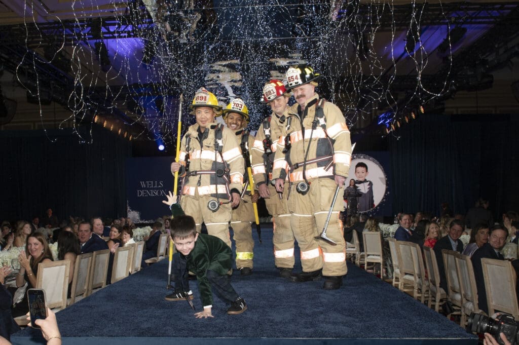 Wells Denison with firefighters from the Highland Park Fire Department (Photo by Tamytha Cameron Photography)
