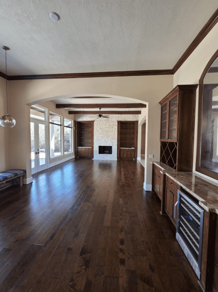 Dark wood and heavy stone were replaced with light floors and a refreshed fireplace area. (Photo by Charbonneau Interiors)