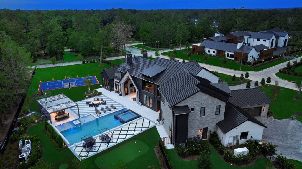 An outdoors that includes a pool/spa, sport court, putting green and kitchen and dining options makes entertaining a dream.