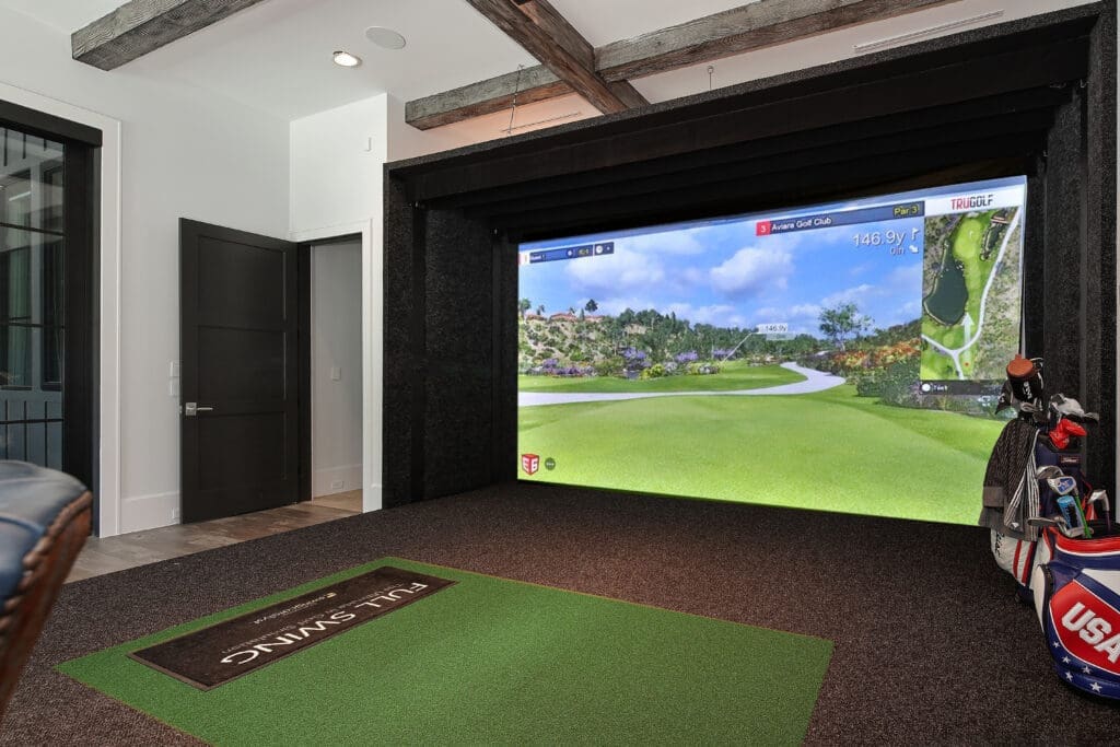 The soundproofed "mancave" area has a golf simulator that can be used for many sports, including soccer.
