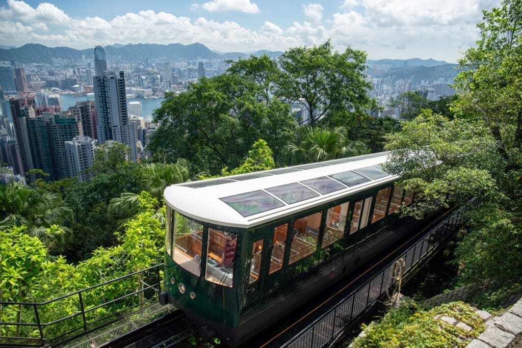 The historic Peak Tram up to Hong Kong's Victoria Peak boasts jaw-dropping views and a peak at the sparkling skyscrapers juxtaposed with the lush forest landscape. 