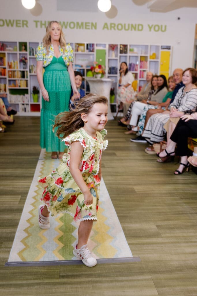 Weezie Lawson make a run for her grandmother leaving mom, Whitney Kuhn Lawson, behind on the runway  at the SheSpace 'Mommy & Me' fashion show (Photo by @LaurenHolubPhotography)