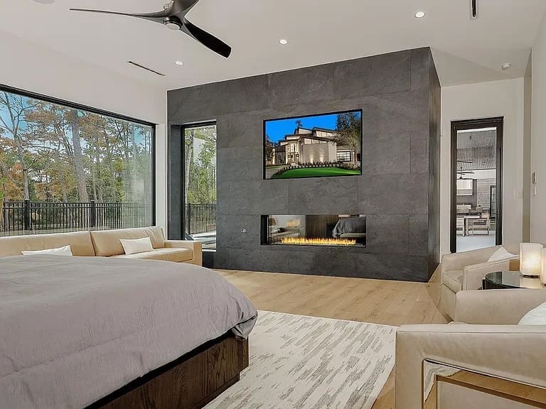 The primary suite features a fireplace, and has views of Lake Woodlands.