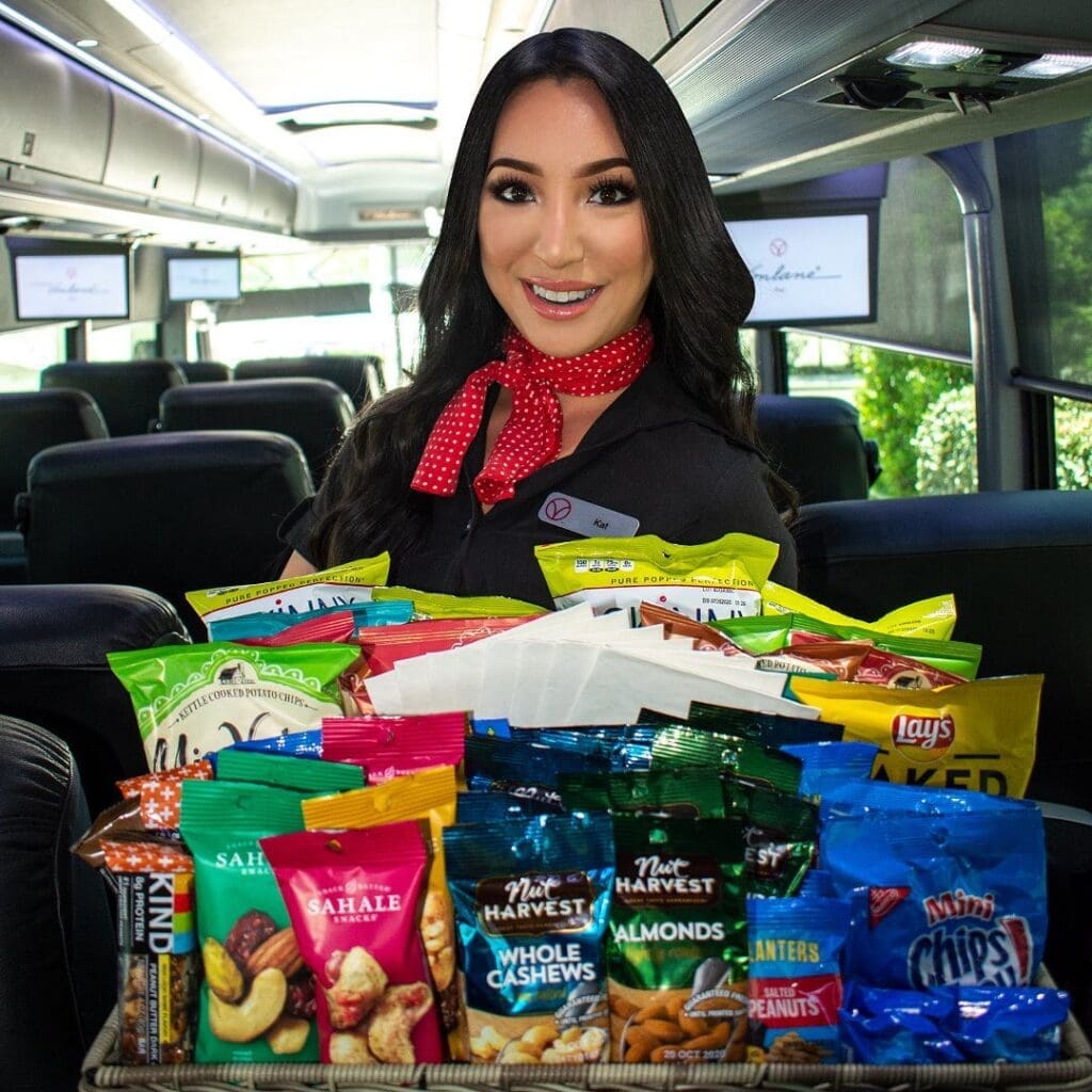 An attendant offers complimentary snacks as part of Vonlane’s onboard experience. (Photo by Vonlane)