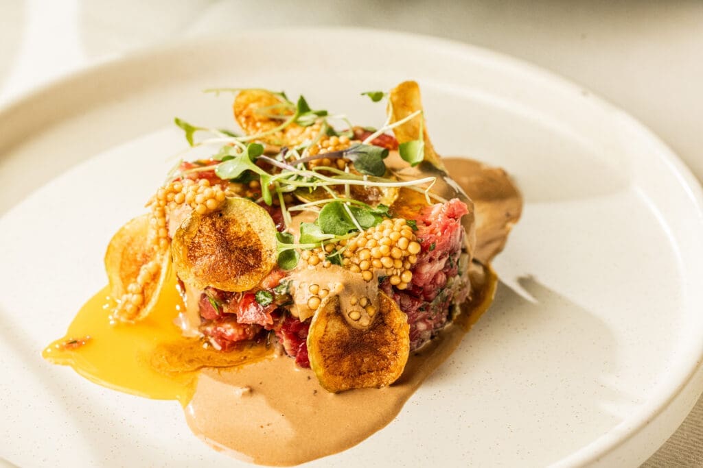 The ELLA menu features steak tartare, bolognese, dumplings, and more comfort cuisine. (Photo by Kathy Tran)