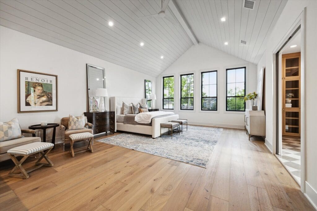 The second floor primary bedroom features a vaulted ceiling, wet bar and sitting area. (Photo by TK Images)