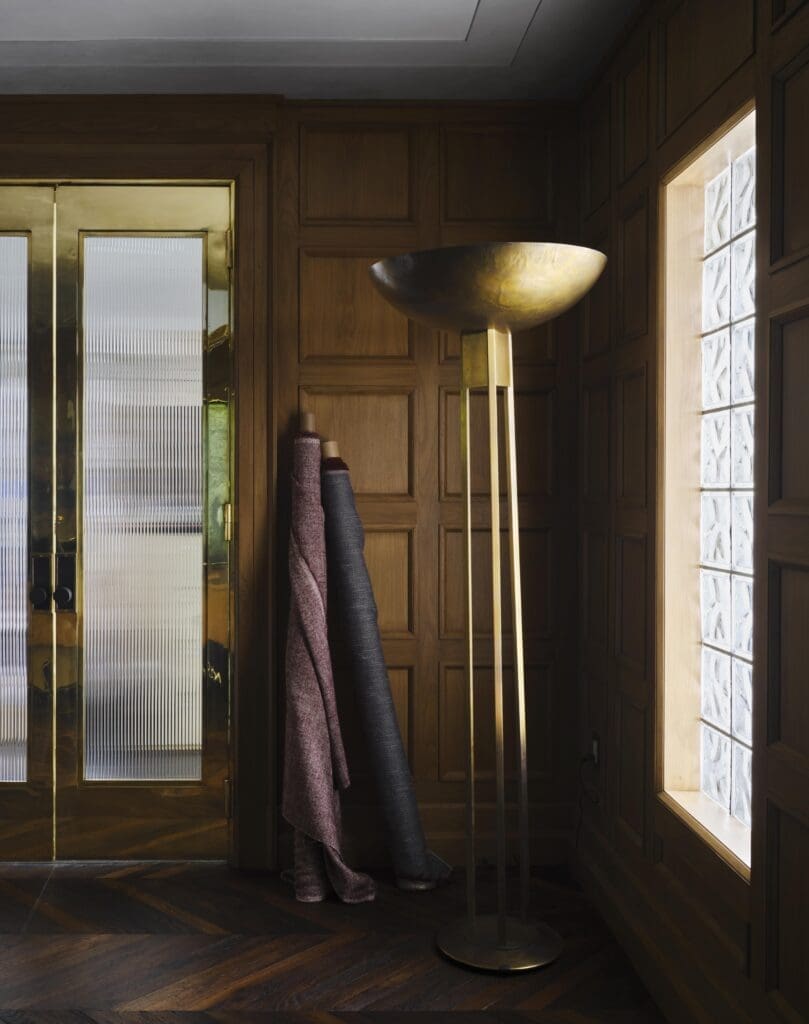 A detail from Moore’s office with a Blackman Cruz floor lamp and custom polished-brass doors with Rocky Mountain Hardware. Stepped ceiling details by Casci Ornamental Plaster.  (Photo by Douglas Friedman)