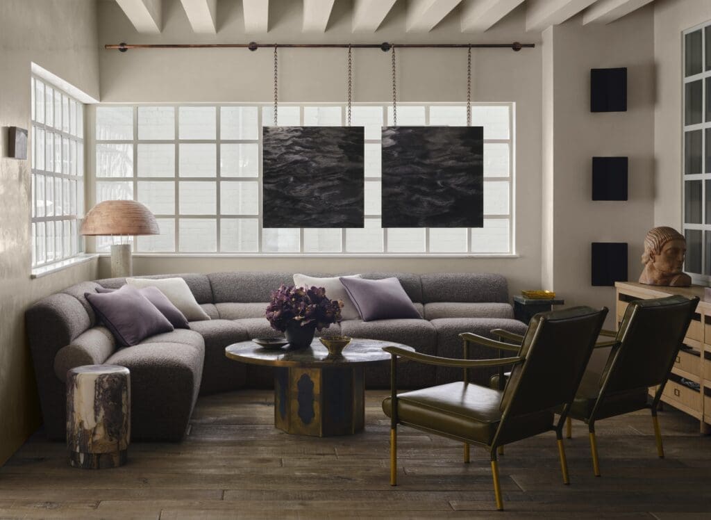 A seating area in the studio with Douglas Levine sofa from The Bright Group.  Artwork by Karen Gunderson and Carlton Nell. (Photo by Douglas Friedman)