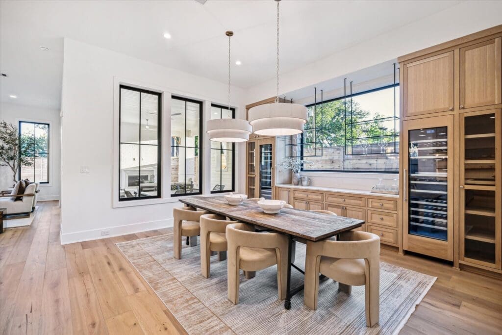 Wine storage units and polished cabinetry in the formal dining area (Photo by TK Images)