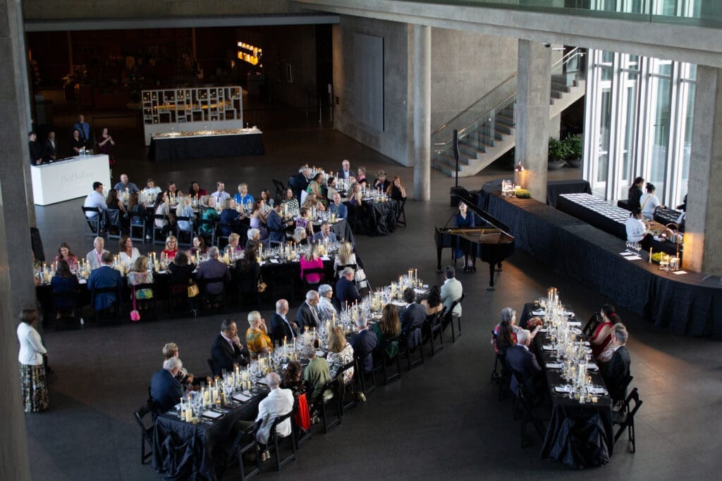 Guests gather beneath the soaring ceilings of The Modern Art Museum for a Champagne-paired dinner and live piano performance. (Courtesy)