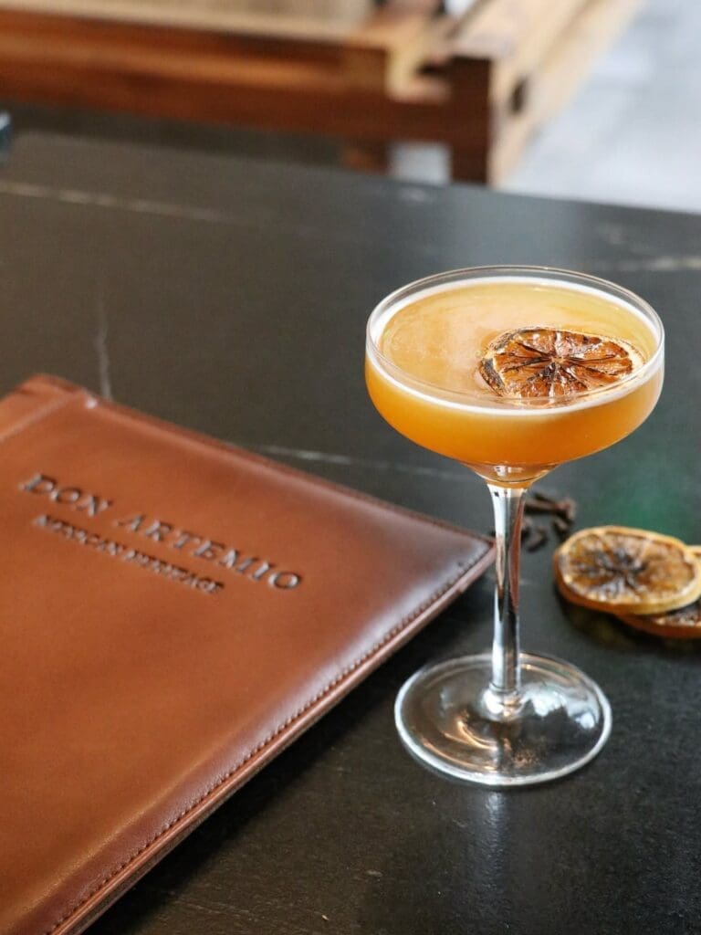 Don Artemio’s Tierra Caliente layers charanda añejo, turmeric mezcal, lime, and charred orange-cinnamon syrup for a smoky, citrus-forward cocktail. (Courtesy)