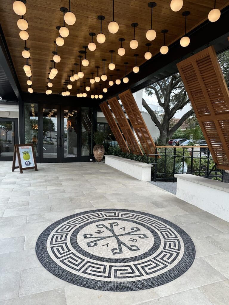 The Yiayia's Greek Restaurant logo in mosiac tiles at the restaurant entry. (Photo by Shelby Hodge)